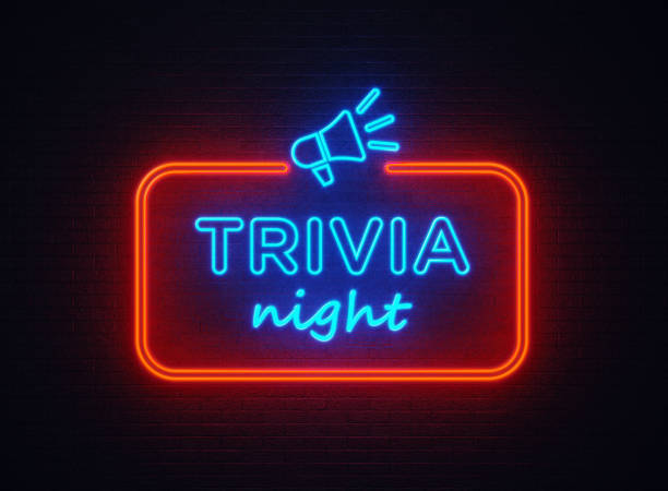 Trivia Night shaped red neon light on black wall. Horizontal composition with copy space.